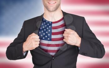 Businessman opening suit to reveal shirt with flag, USA