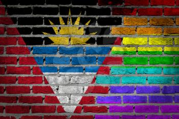 Dark brick wall texture - coutry flag and rainbow flag painted on wall - Antigua and Barbuda