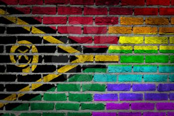 Dark brick wall texture - coutry flag and rainbow flag painted on wall - Vanuatu