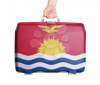 Used plastic suitcase with stains and scratches, printed with flag, Kiribati