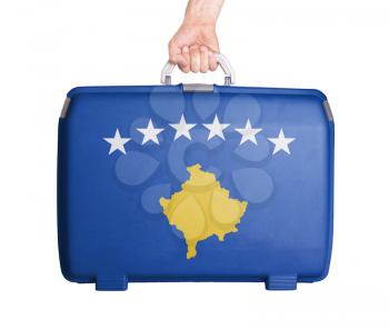 Used plastic suitcase with stains and scratches, printed with flag, Kosovo