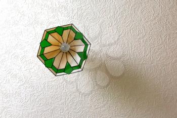 Antique ceiling lamp hanging on a white ceiling