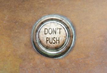 Grunge image of an old button - don't push