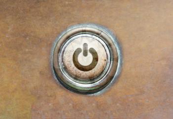 Grunge image of an old button - power
