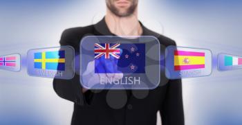 Hand pushing on a touch screen interface, choosing language or country, New Zealand