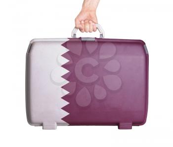 Used plastic suitcase with stains and scratches, printed with flag, Qatar