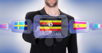 Hand pushing on a touch screen interface, choosing language or country, Uganda
