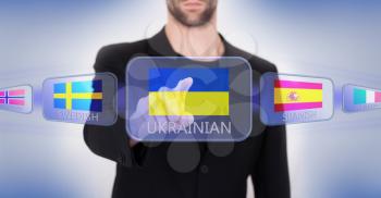 Hand pushing on a touch screen interface, choosing language or country, Ukraine