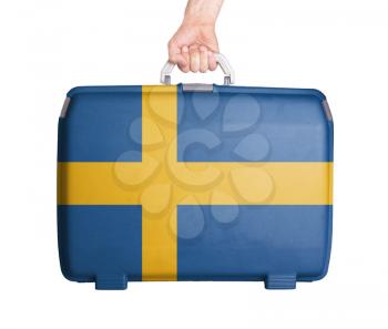 Used plastic suitcase with stains and scratches, printed with flag, Sweden