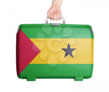 Used plastic suitcase with stains and scratches, printed with flag, Sao Tome and Principe