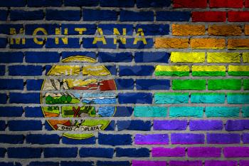 Dark brick wall texture - coutry flag and rainbow flag painted on wall - Montana