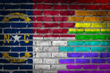 Dark brick wall texture - coutry flag and rainbow flag painted on wall - North Carolina