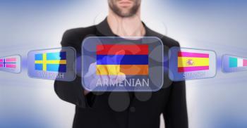 Hand pushing on a touch screen interface, choosing language or country, Armenia