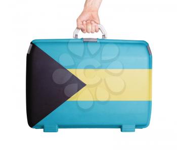 Used plastic suitcase with stains and scratches, printed with flag, Bahamas