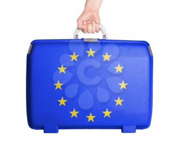 Used plastic suitcase with stains and scratches, printed with flag, EU