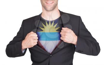 Businessman opening suit to reveal shirt with flag, Antigua and Barbuda