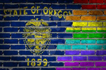 Dark brick wall texture - coutry flag and rainbow flag painted on wall - Oregon