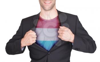 Businessman opening suit to reveal shirt with flag, Luxembourg