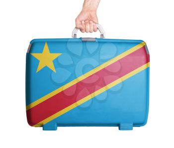 Used plastic suitcase with stains and scratches, printed with flag, Congo