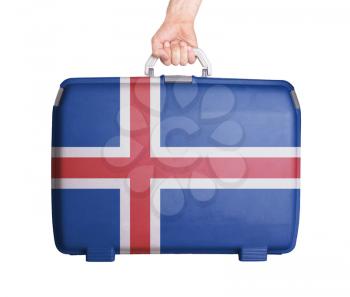 Used plastic suitcase with stains and scratches, printed with flag, Iceland