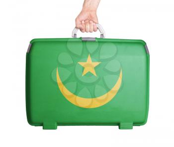 Used plastic suitcase with stains and scratches, printed with flag, Mauritania