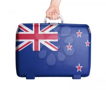 Used plastic suitcase with stains and scratches, printed with flag, New Zealand