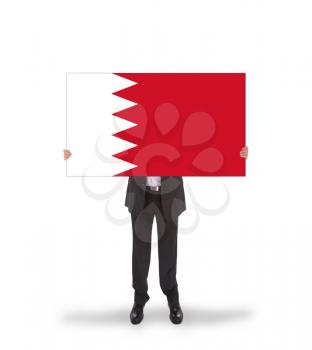 Businessman holding a big card, flag of Bahrain, isolated on white