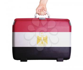 Used plastic suitcase with stains and scratches, printed with flag, Egypt