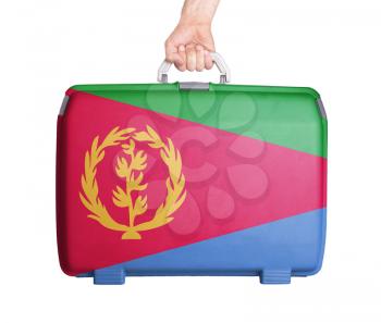Used plastic suitcase with stains and scratches, printed with flag, Eritrea