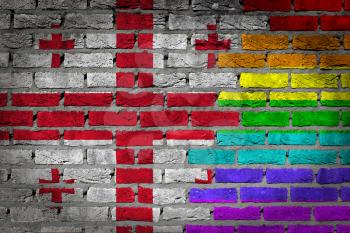 Dark brick wall texture - coutry flag and rainbow flag painted on wall - Georgia