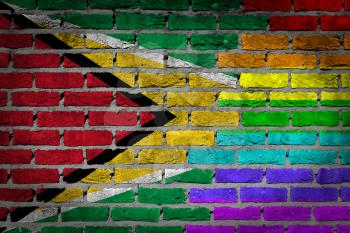 Dark brick wall texture - coutry flag and rainbow flag painted on wall - Guyana
