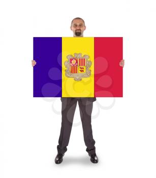Businessman holding a big card, flag of Andorra, isolated on white
