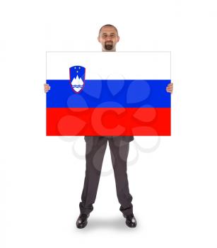 Businessman holding a big card, flag of Slovenia, isolated on white