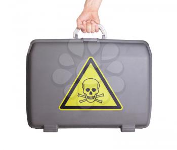 Used plastic suitcase with stains and scratches, danger, poisonous