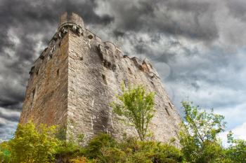 Stormy sky over ruins of a small castle