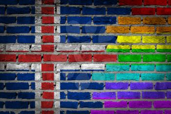 Dark brick wall texture - coutry flag and rainbow flag painted on wall - Iceland