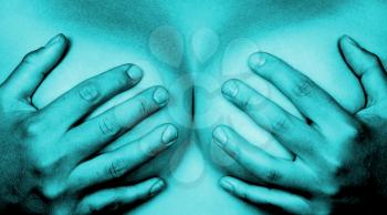 Upper part of female body, hands covering breasts, blue
