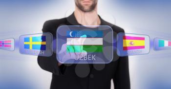 Hand pushing on a touch screen interface, choosing language or country, Uzbekistan