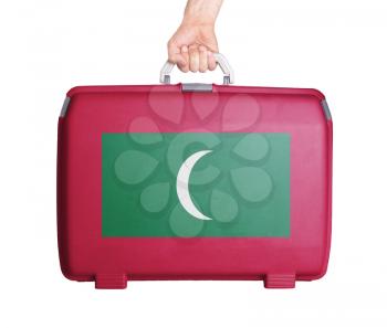 Used plastic suitcase with stains and scratches, printed with flag, Maldives