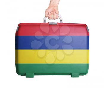 Used plastic suitcase with stains and scratches, printed with flag, Mauritius