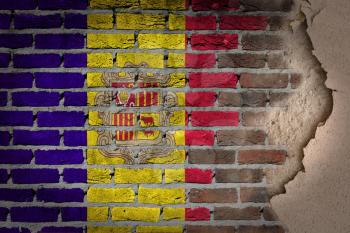 Dark brick wall texture with plaster - flag painted on wall - Andorra