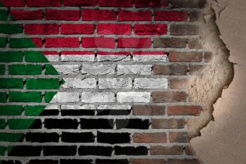 Dark brick wall texture with plaster - flag painted on wall - Sudan