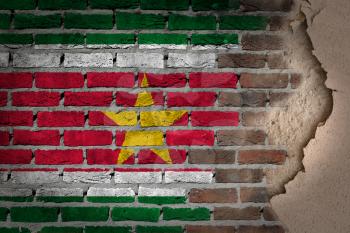 Dark brick wall texture with plaster - flag painted on wall - Suriname