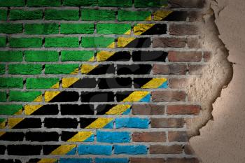 Dark brick wall texture with plaster - flag painted on wall - Tanzania