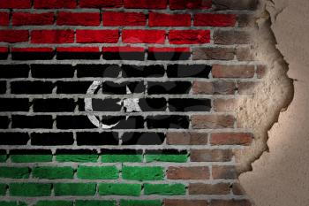 Dark brick wall texture with plaster - flag painted on wall - Libya
