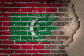 Dark brick wall texture with plaster - flag painted on wall - Maldives