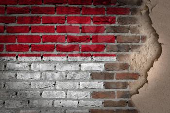 Dark brick wall texture with plaster - flag painted on wall - Monaco