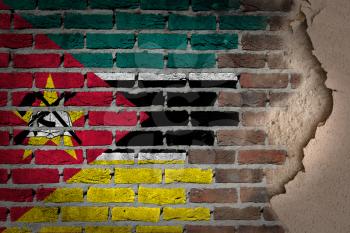 Dark brick wall texture with plaster - flag painted on wall - Mozambique