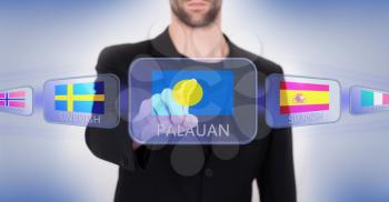 Hand pushing on a touch screen interface, choosing language or country, Palau