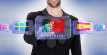 Hand pushing on a touch screen interface, choosing language or country, Portugal